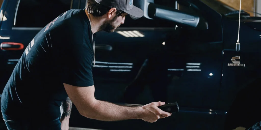 Detailer working on a black vehicle