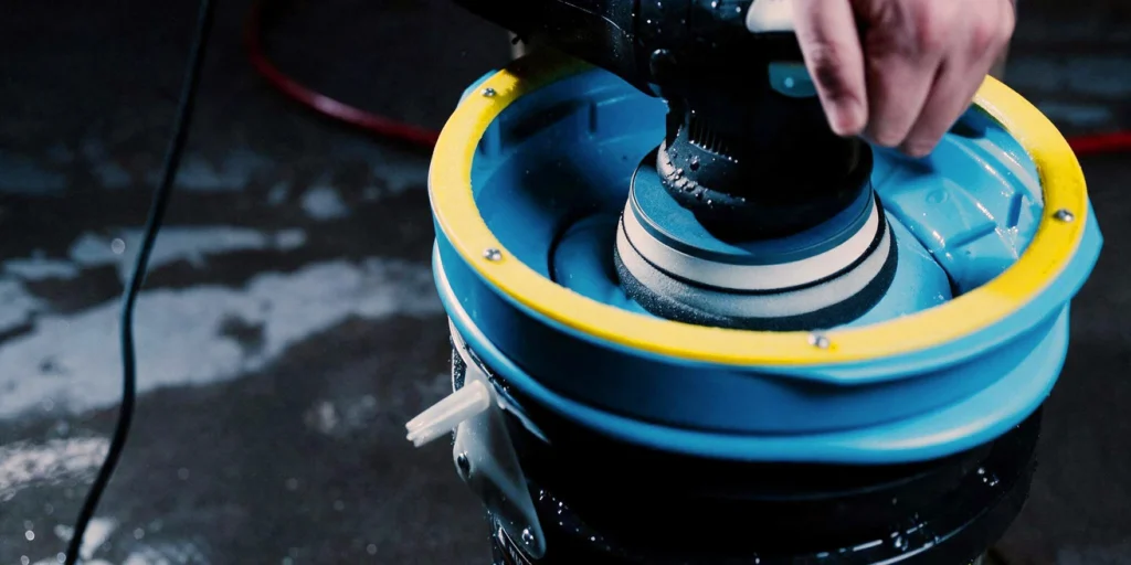A buffing pad being washed in the Lake Country System 4000® Pad Washer